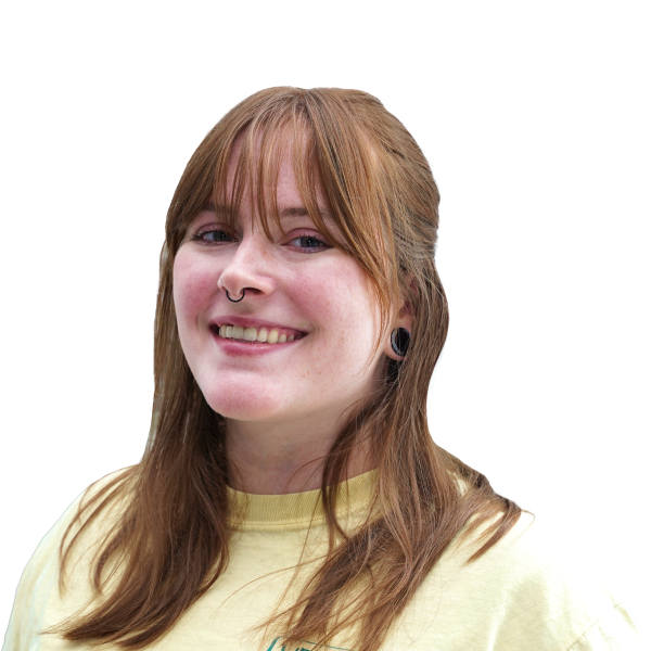 Headshot of a smiling woman, long reddish hair with bangs.