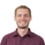 Portrait of a smiling man in burgundy shirt, transparent background.