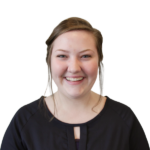 Headshot of a smiling woman with a black blouse.