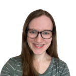 Smiling woman with glasses and long hair against a white background