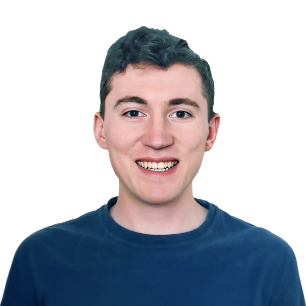 Headshot of a smiling man in blue shirt on a black background.